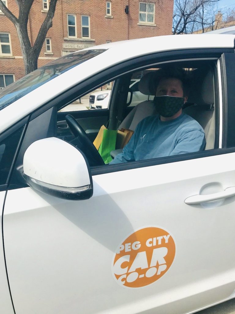Delivery volunteer in a Peg City Car
