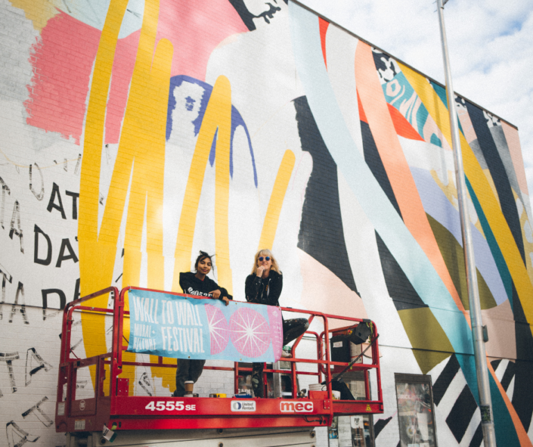 Cyndie Belhumeur, Shaneela Boodoo infront of collaborative mural