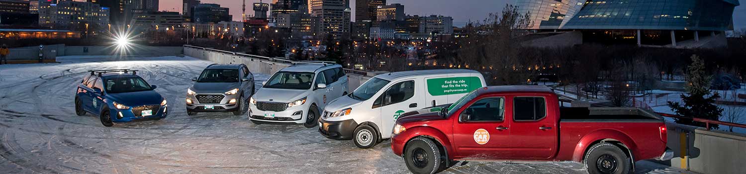 various styles of peg city vehicles next to one another in front of the Provencher Bridge in Winnipeg